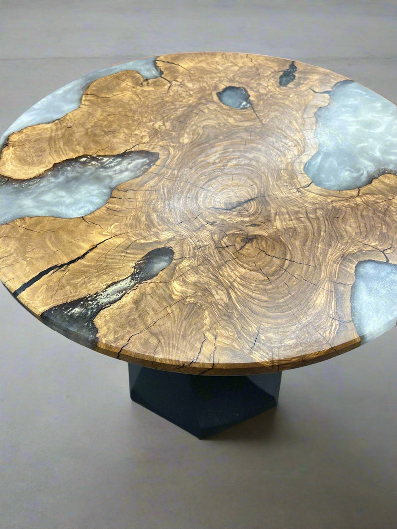 Olive wood table with white gold accents and black metal base